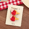 Red racket for table tennis, hairgrip, kitten