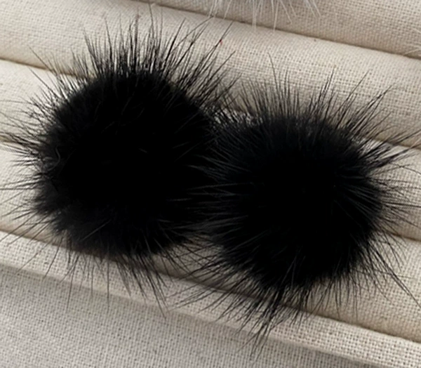 A pair of black fur ball earrings