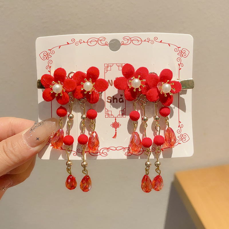 12 un par de horquillas de doble flor con flecos