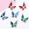 The new left and right symmetrical drip oil butterfly jewelry double hanging pendant DIY ancient wind hair decoration flowing souvenir alloy accessories spot spot