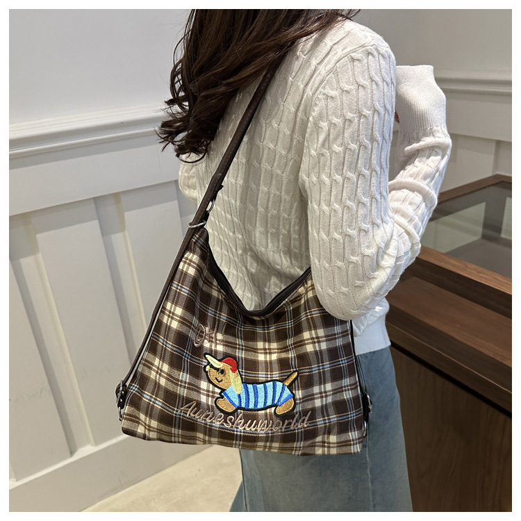 A new 2024 trendy and stylish backpack for women, featuring a cartoon checkered single-shoulder crossbody bag and a tote bag undefined