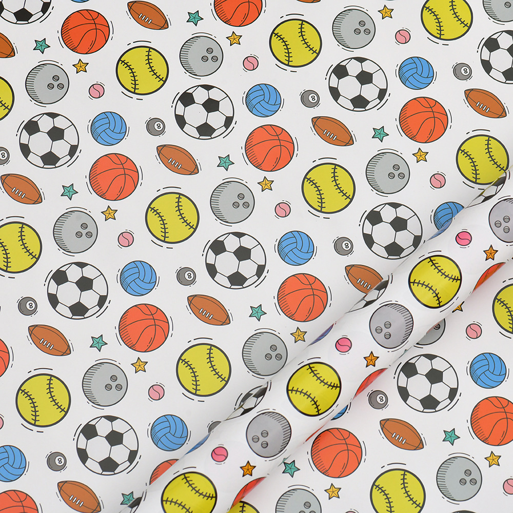 Nuevo papel de regalo de dibujos animados transfronterizo al por mayor Papel de embalaje de baloncesto de fútbol del Día de los niños en stock