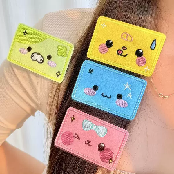 Cartoon emoji embroidered hair clips, featuring a cute design, with Velcro fasteners, perfect for students to use to style and secure their hair