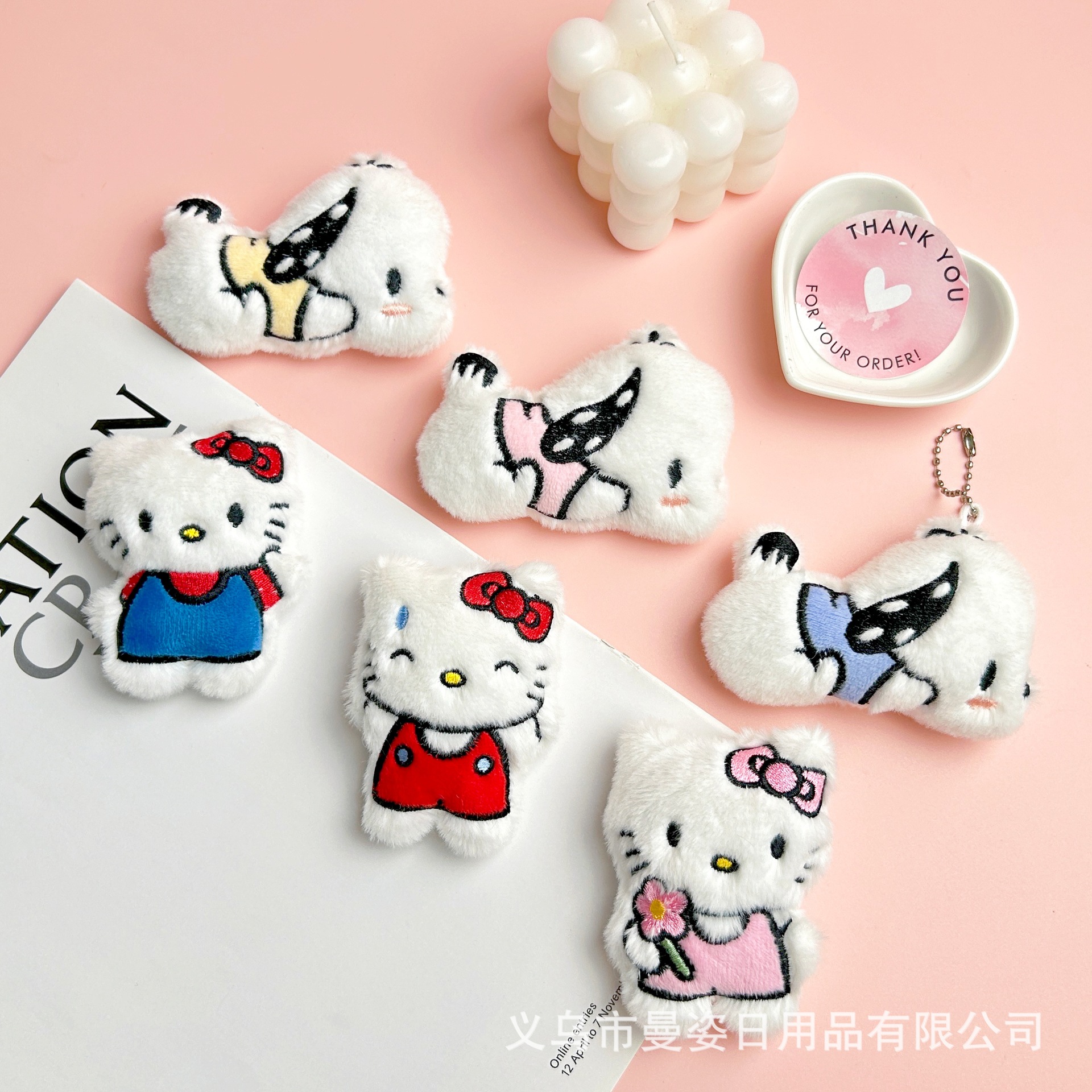 Is this a cartoon Hello Kitty squeaking keychain, plush toy, or a KT Pacha brooch/bag accessory?