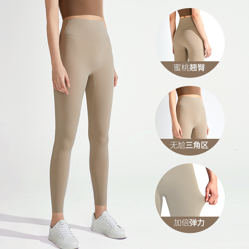 Nuevos pantalones de yoga desnudos transfronterizos Lycra de cintura alta de mujer pantalones de fitness de levantamiento de cadera deportes al aire libre ropa de yoga ajustada de secado rápido