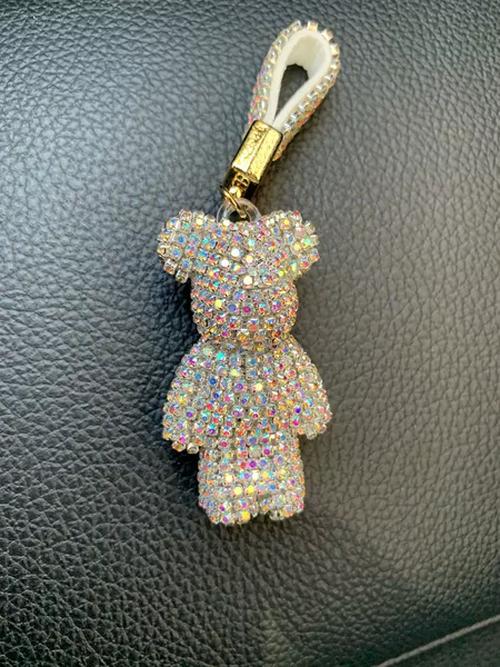 White AB bear + gold buckle leather rope