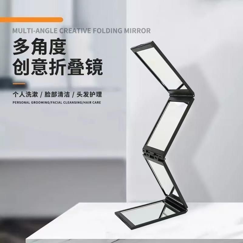 Folding handheld mirror