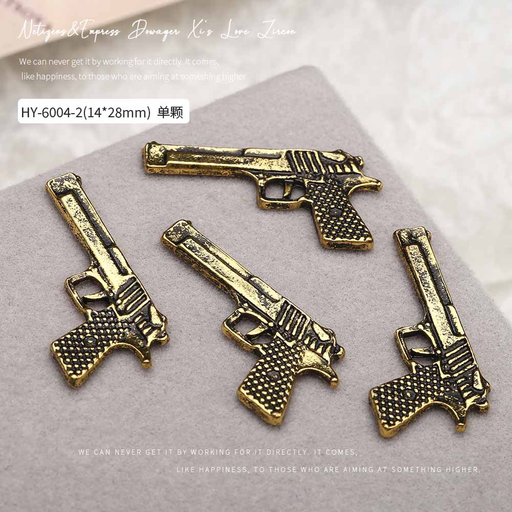 Europa y los Estados Unidos en línea con diamantes AK armas de manicuría joyas de simulación de personalidad tridimensional armas de fuego decoración de uñas al por mayor