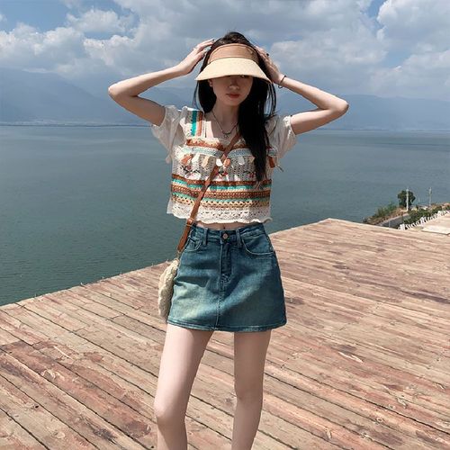 Leather-lined stretch denim short skirt for 2025, high-waisted, flattering for petite figures, showcasing a curvy silhouette.