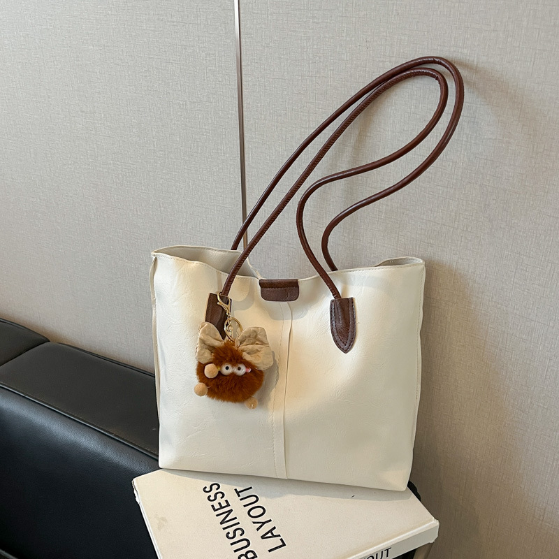 Moda de gran capacidad de la cara suave 2025 primavera nuevo colgante de ocio retro color sólido simple bolso de hombro axilar de mano