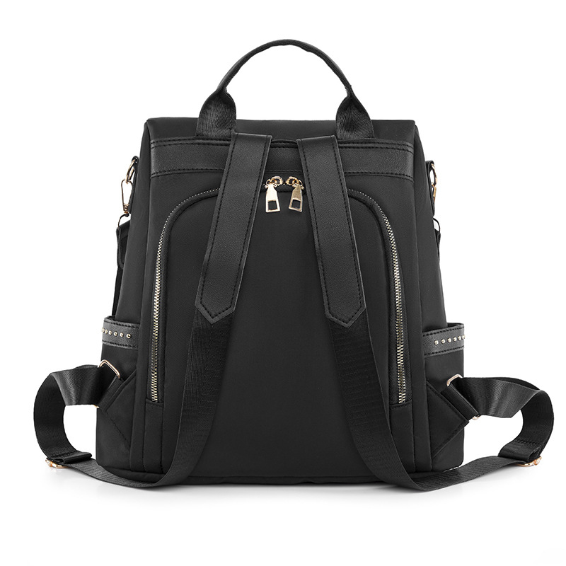 Venta al por mayor 2023 nuevo estilo casual mochila antirrobo mujer simple moda Oxford tela remache mochila escolar de doble uso