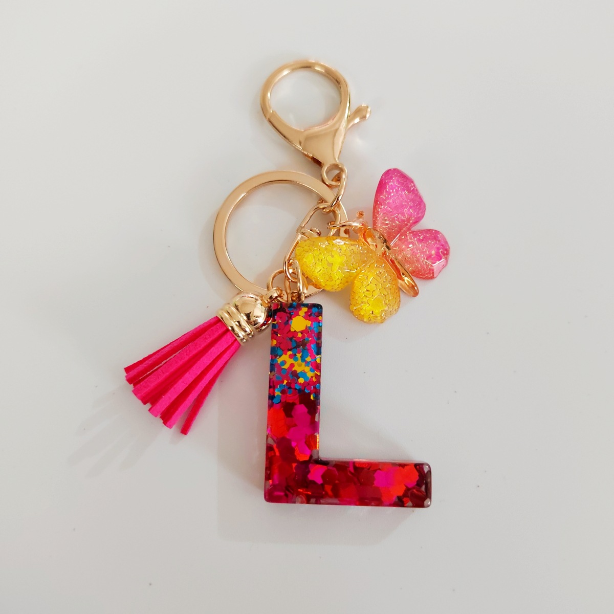 Ventas transfronterizas calientes de letras inglesas de color mixto colgante de llavero colgante de mariposa fringe de resina de llavero colgante de joyería