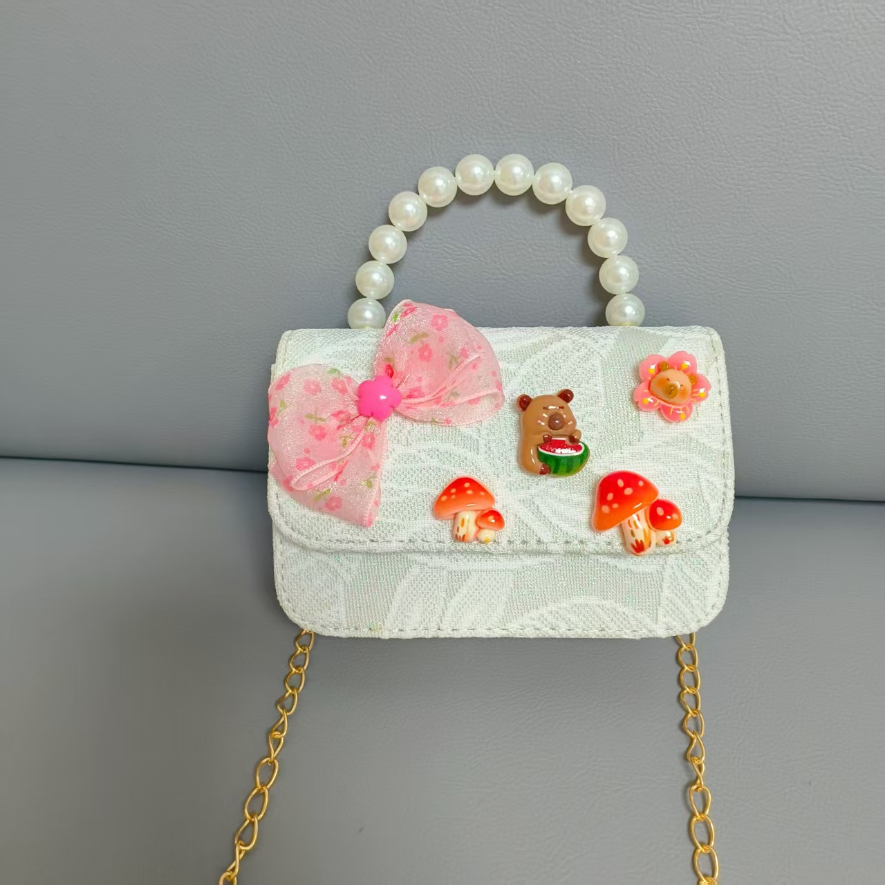 Bolsos para niños nuevos bolsos de perlas de arco para niñas bolsos de cinturón de estilo de fragancia bolsos de cadena bolsos de cambio bolsos