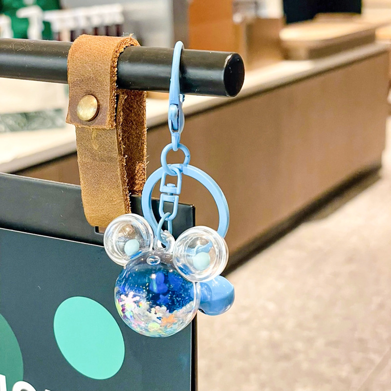 Caricatura en aceite líquido arena flotante botella mochila llavero delicado colgante accesorios accesorios máquina de muñecas pequeños regalos al por mayor