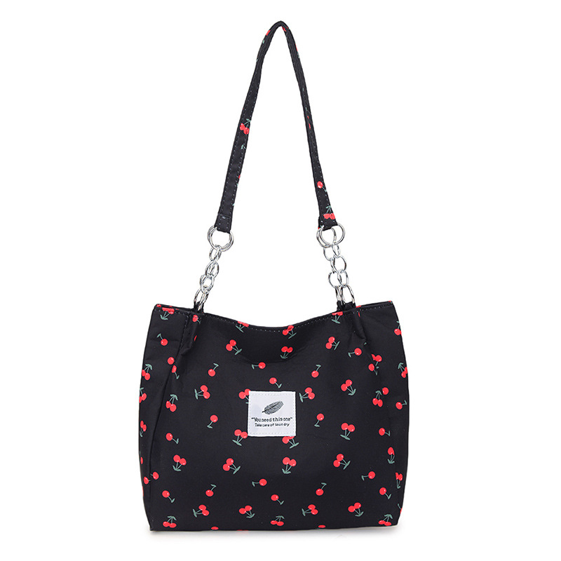 Moda pequeña y fresca impresión de cereza bolsos de invierno 2025, bolsos de mujer nuevos, bolsos de gran capacidad, bolsos de mujer de estilo exterior.