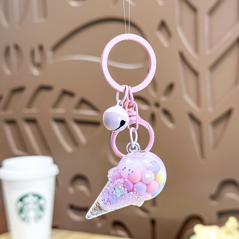 Caricatura en aceite líquido arena flotante botella mochila llavero delicado colgante accesorios accesorios máquina de muñecas pequeños regalos al por mayor