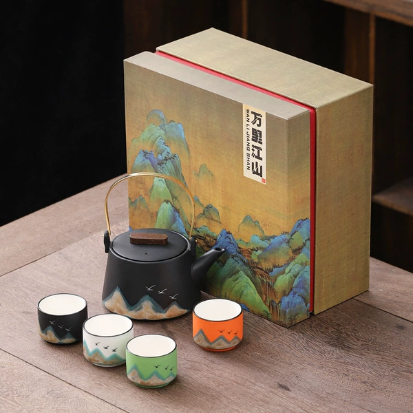 Black teapot with four cups