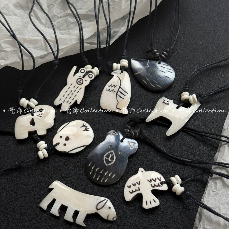 Nepalese Hand-Carved Bone Necklace Pendant with Smiley Face Cartoon Animals: Puppy, Penguin, Cherry, Elephant Nepalese Hand-Carved Bone Necklace Pendant with Smiley Face Cartoon Animals: Puppy, Penguin, Cherry, Elephant