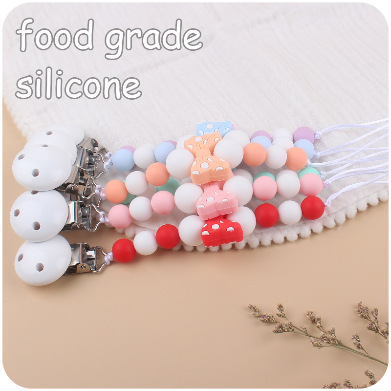 Suministros para bebés hemu clip de chupete calmante bebé de dibujos animados arco mordedura pegamento cadena de chupete cadena anti-caída nueva