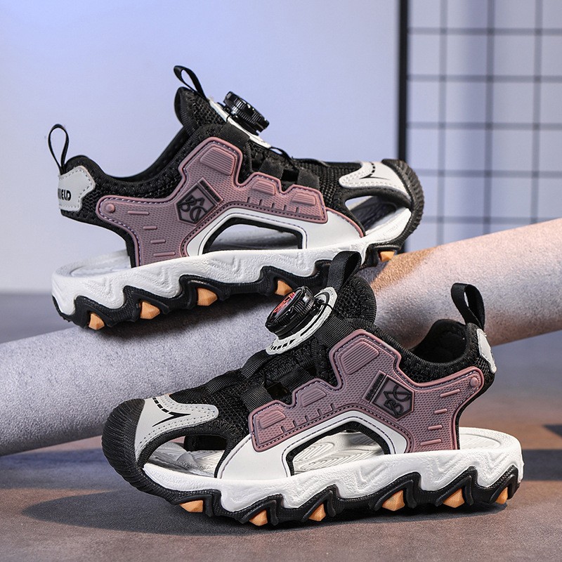 Verano 2025 nuevo estilo sandalias de malla hueca para niños zapatos de playa Baotou botones giratorio sandalias deportivas para niños de suela suave