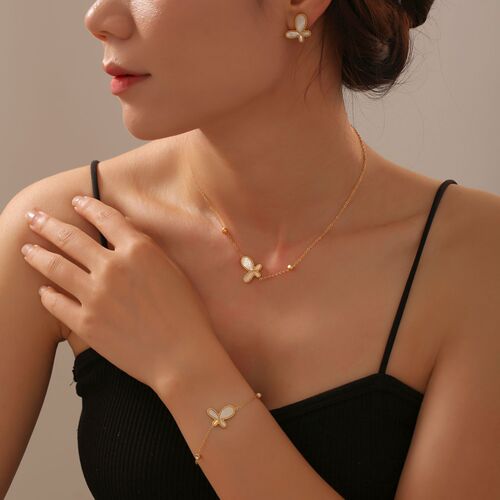 Elegant French-style jewelry set featuring a delicate, butterfly-shaped pendant with white shell inlay and a gentle, feminine design—crafted from titanium steel with gold-plated finish.