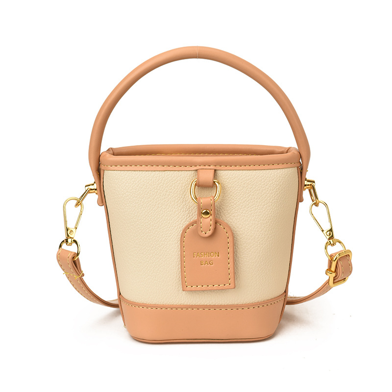 Mini pequeño bolso de cubo de mano para niños 2026 nuevo estilo de alta calidad de moda versátil bolso de mochila de estilo exterior