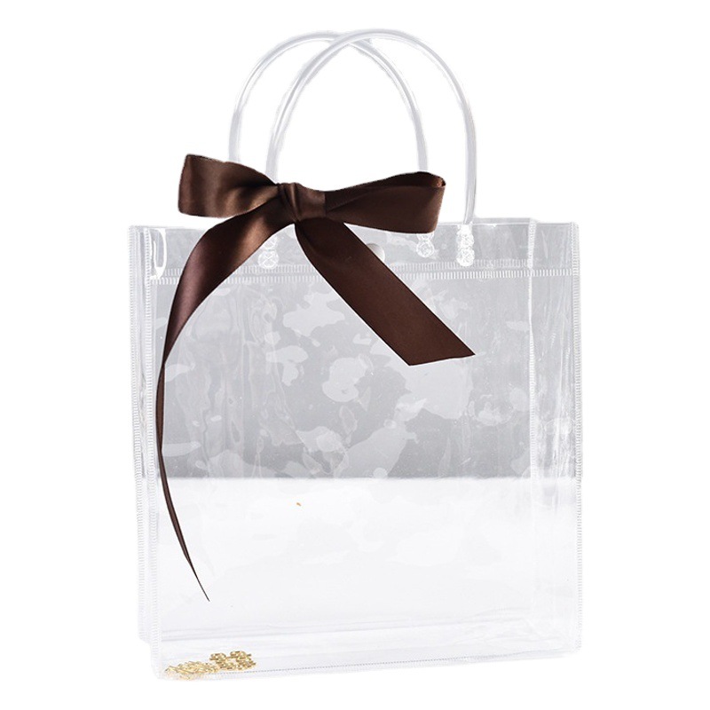 Bolsa de mano transparente de PVC, bolsa de regalo de plástico en stock, bolsa de embalaje de regalo portátil, bolsa de transporte con logo.