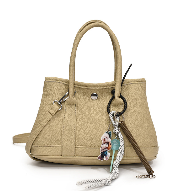 Nicho de moda explosivo bolso de cubo portátil para mujeres 2025 nuevo estilo universal simple bolso de mochila de moda extranjera bolso de mochila