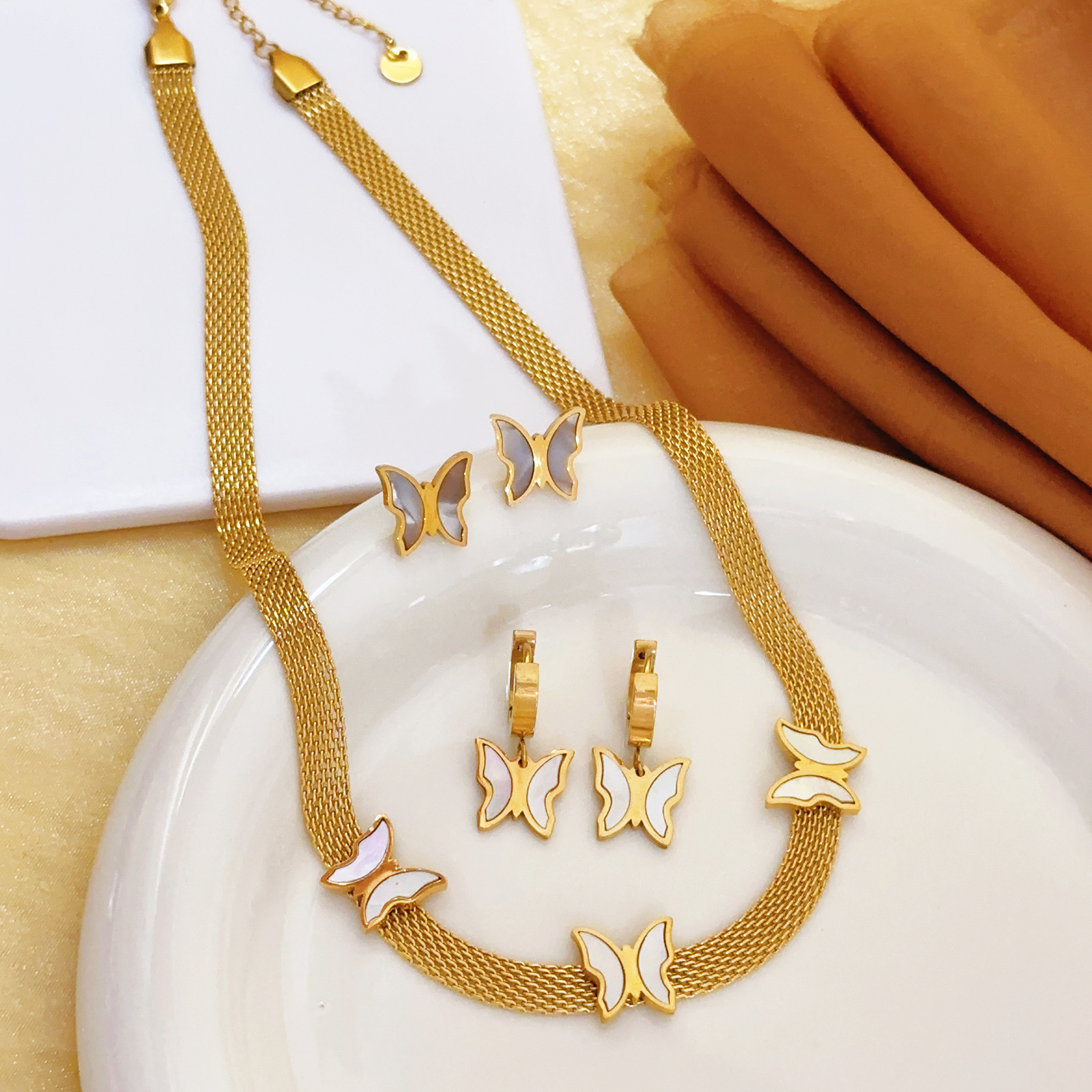 Cadena de cuchillas de venta caliente transfronteriza europea y americana mariposa concha blanca collar retro colgante tejido simple pendientes mujeres moda de lujo ligero
