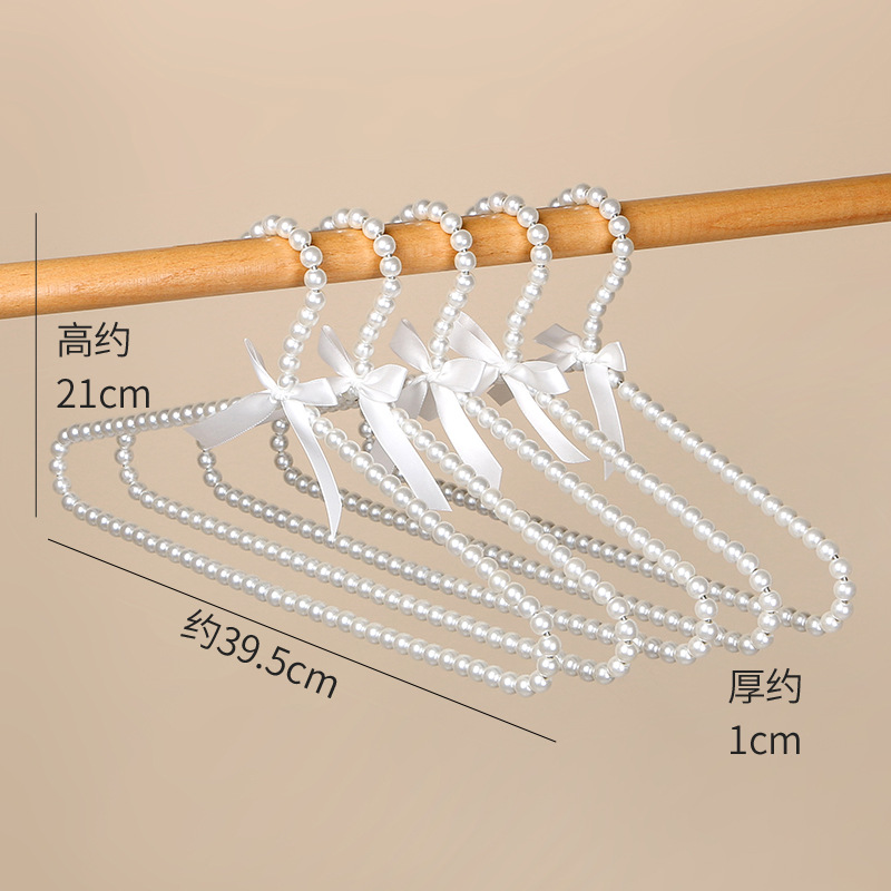 Tienda de ropa de mujer perla lujo ligero vestido retro arco adulto percha de ropa infantil estilo europeo hadas soporte de abrigo