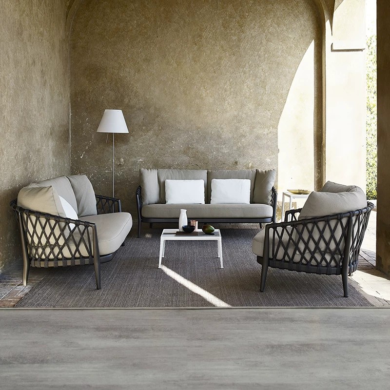 Nordic-style outdoor sofa set, waterproof and sun-resistant, with rattan weaving, suitable for villas, gardens, and outdoor spaces, featuring a minimalist design