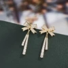 Golden earrings with bow