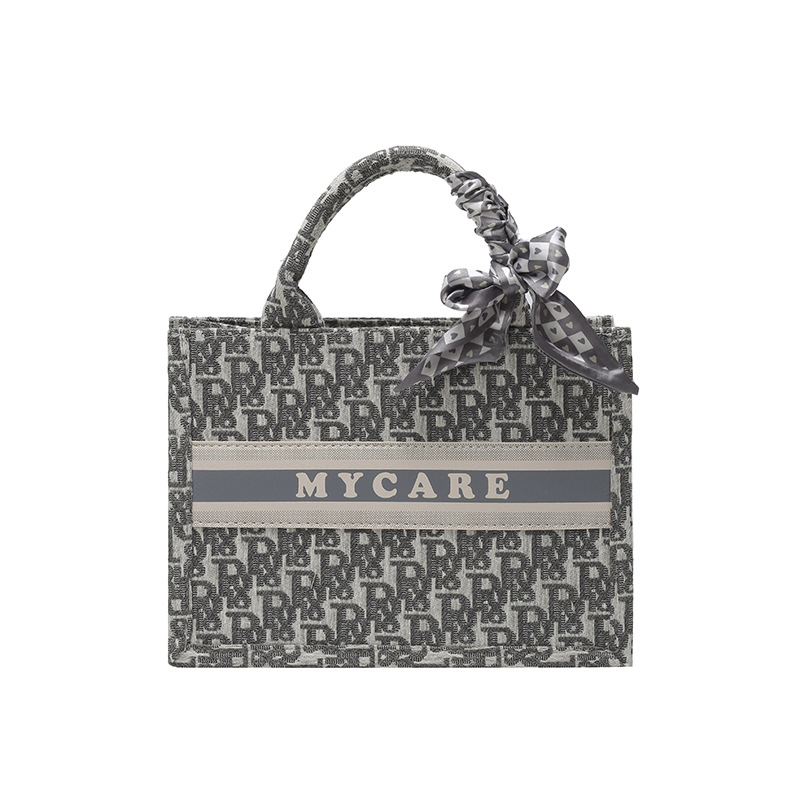 Bolsos bordados de alta calidad para mujeres 2026 nuevas letras de tela transfronterizas retro bolsas de mano de transporte de gran capacidad