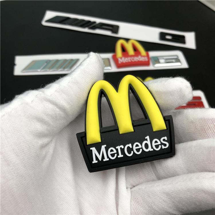 Mercedes-Benz C-Class, E-Class, and S-Class modified with AMG emblems, McDonald's car logos, BMW M logos, and new AMG tail emblems with black lettering