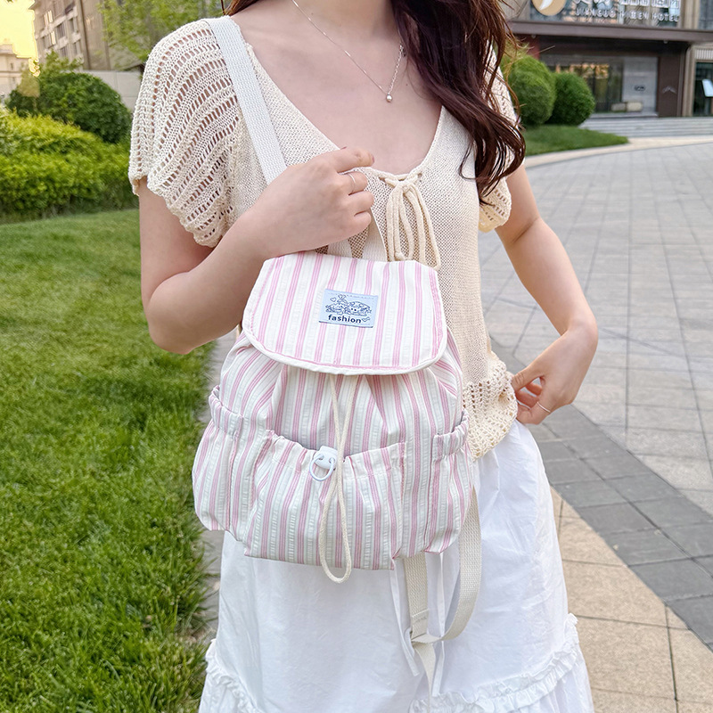 Bolsa de lona a rayas casuales de viento universitario para mujeres verano 2026 nueva mochila simple de gran capacidad mochila de estudiantes