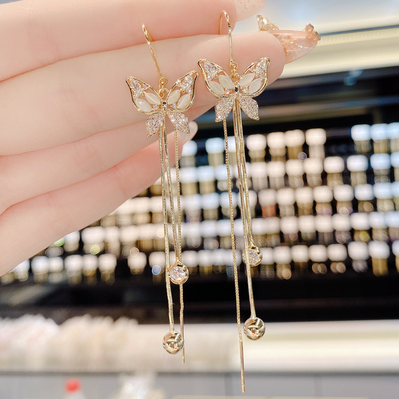 S925 aguja de plata Corea del Sur Dongdaemun elegante micro con incrustaciones de circón mariposa borla anti-perdida hilo de oreja moda pendientes del todo-fósforo para las mujeres