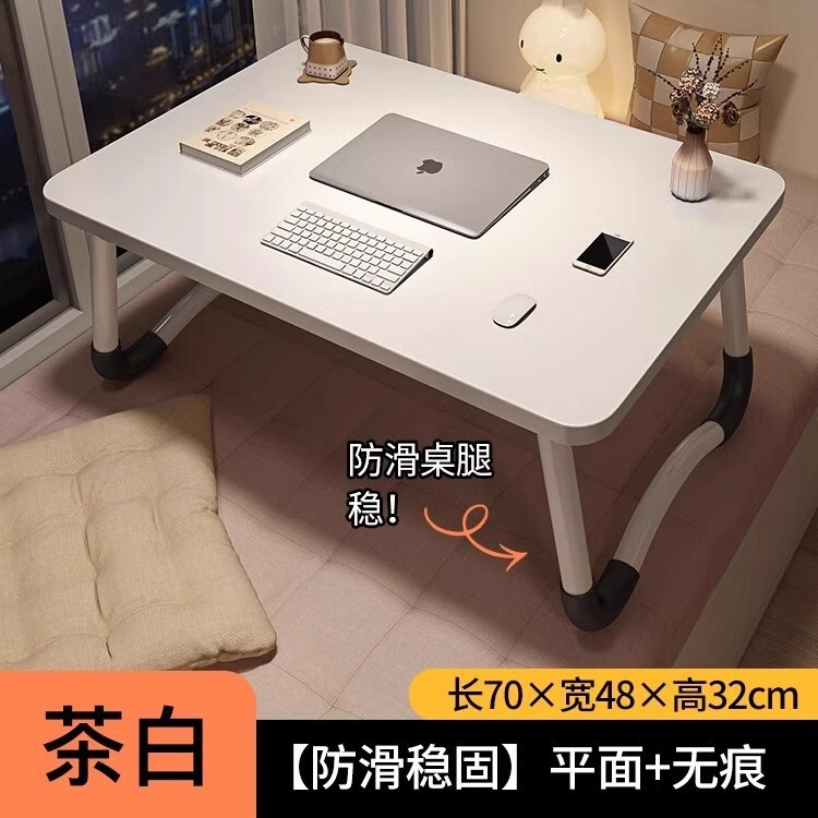 折り畳み可能なベッドの上の小さなテーブルは机のノートパソコンのテーブルを勉強します。|undefined