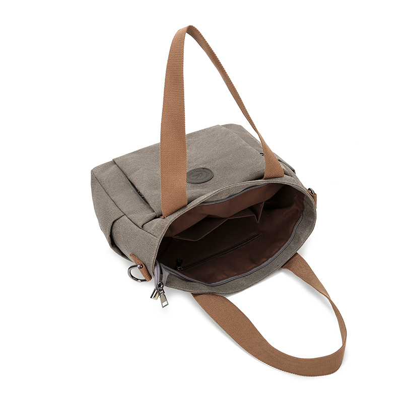 2025 bolsas de mujer europeas y estadounidenses transfronterizas nuevas bolsas de viaje de gran capacidad bolsas de hombro de lona de color sólido bolsas de brazo