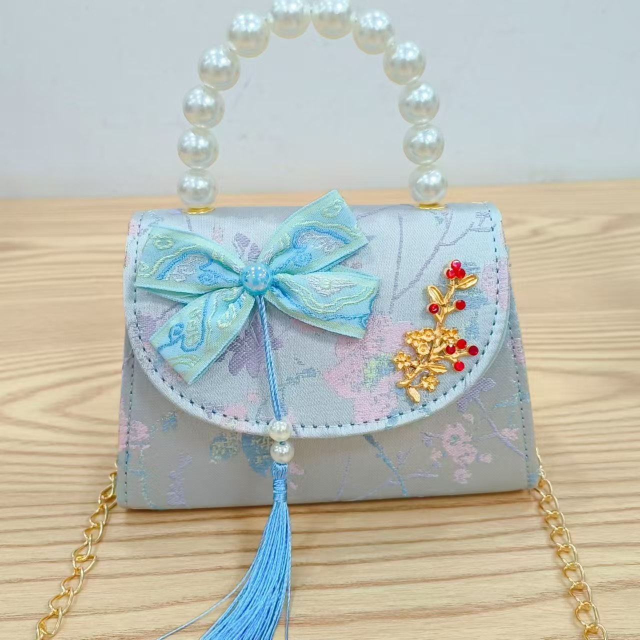 Bolsas de niños arco de estilo chino borda de niña pequeña princesa perla bolsa de cambio de mano al por mayor