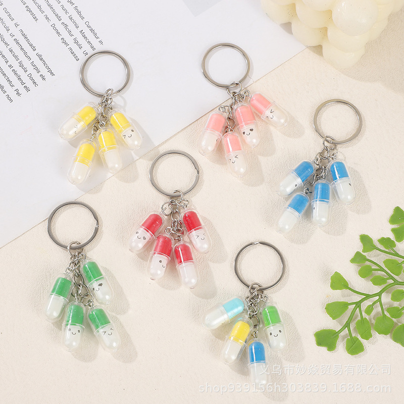 Cross-border new cute smiley face capsule pendant keychain pendant fashion creative fun pill key chain wholesale