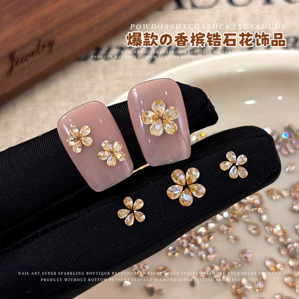 New champagne-colored cubic zirconia flower nail art decorations, featuring sparkling, iridescent, and various sizes of water droplet cubic zirconia flowers for DIY nail art