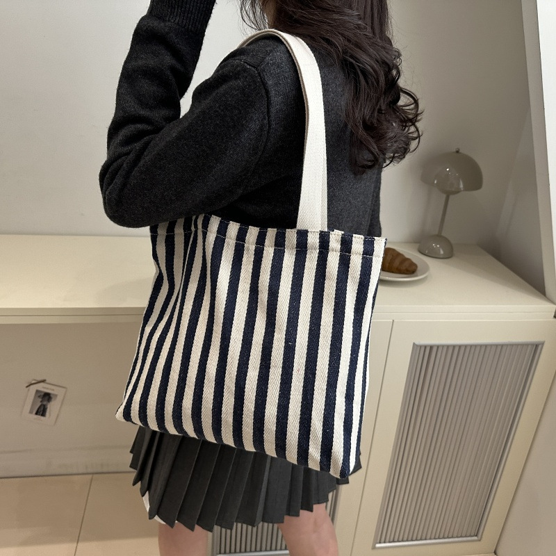 The new cross-border vertical striped commuter tote bag, hand-held shoulder bag, is fashionable and has a large capacity. It features an InS-style simple letter sail undefined