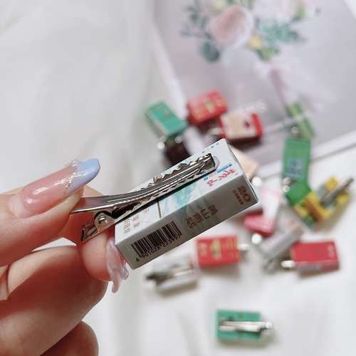 Original, fun hair clips with a girly, quirky vibe—featuring a row of lifelike Wangzai Milk-flavored cigarette designs, perfect as adorable side clips for students' bangs!
