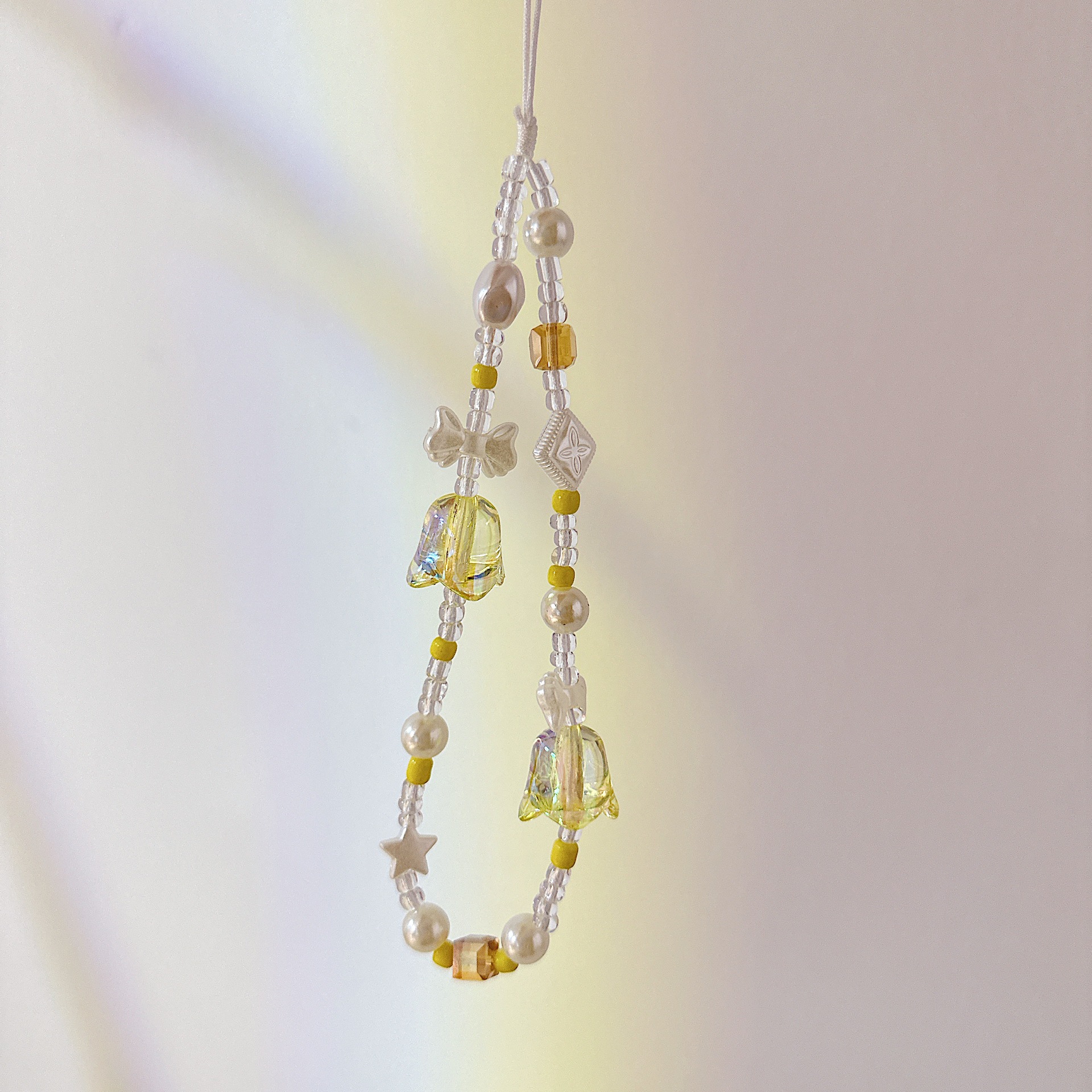 Aplicable cadena coreana orquídea de campana cadena de muñeca arco cuentas de caso de teléfono móvil colgante anti-perdida colgar pulsera trenzada