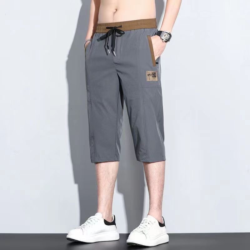 Pantalones cortos de siete puntos para hombres de verano delgados sueltos de moda versátil pantalones casuales bordados con cremallera anti-robo pantalones rápidos de moda para hombres