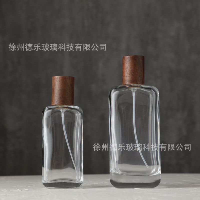 Botella de perfume de cristal al por mayor 30mL 50mL 100mL perfume plano sub-botella de empaquetado tapa de madera botella de perfume vacía
