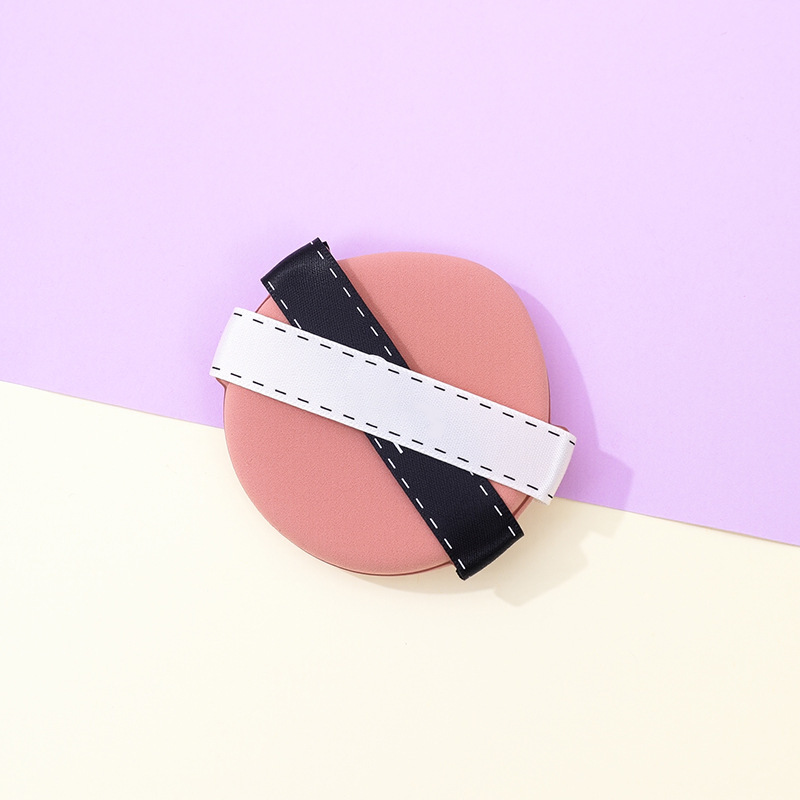 La borla de polvo de cinta de dos colores personalizada de fábrica no come polvo, gotas de agua sin látex, esponja de maquillaje de seis lados en forma de diamante, cojín de aire al por mayor