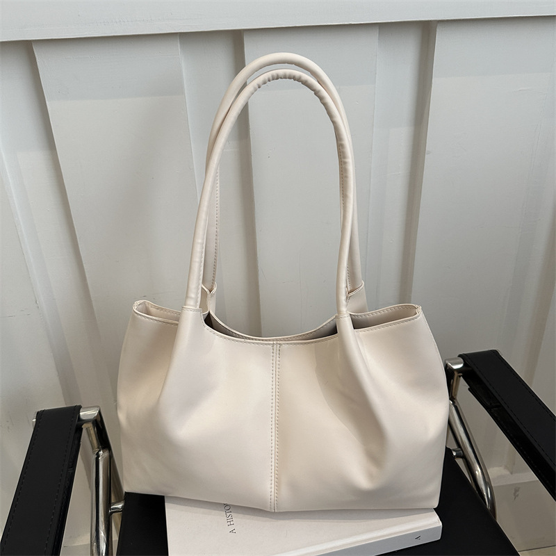 Este año, la sensación de relajación de la moda de color sólido 2024, el nuevo tipo de bolso de hombro simple de gran capacidad, bolso de mano de empalme de moda