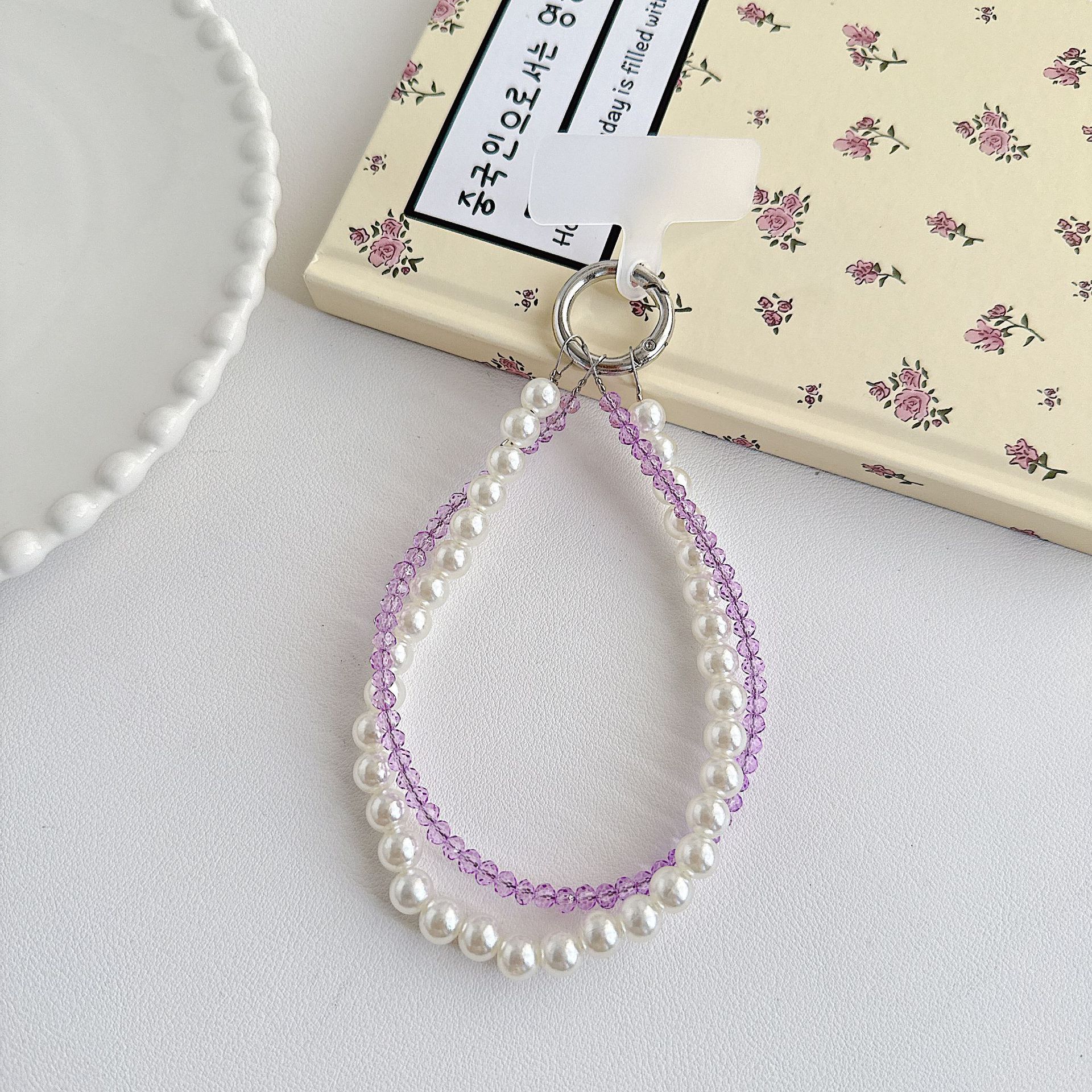 Boutique hecho a mano de alta gama teléfono móvil cadena colgante mujer estilo ins cristal coreano perla enrollamiento cadena de muñeca moda corta