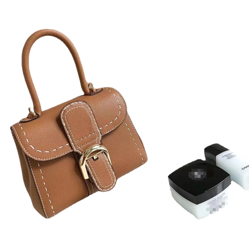 Bolso de mano con hebilla de herradura, modelo nuevo de 2025, bandolera de cuero de vaca granulado de primera capa, bolso de sillín informal y versátil.